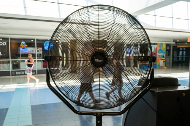 People walk by a fan through a Staten Island terminal on a hot afternoon in Manhattan on July 19th, 2022.